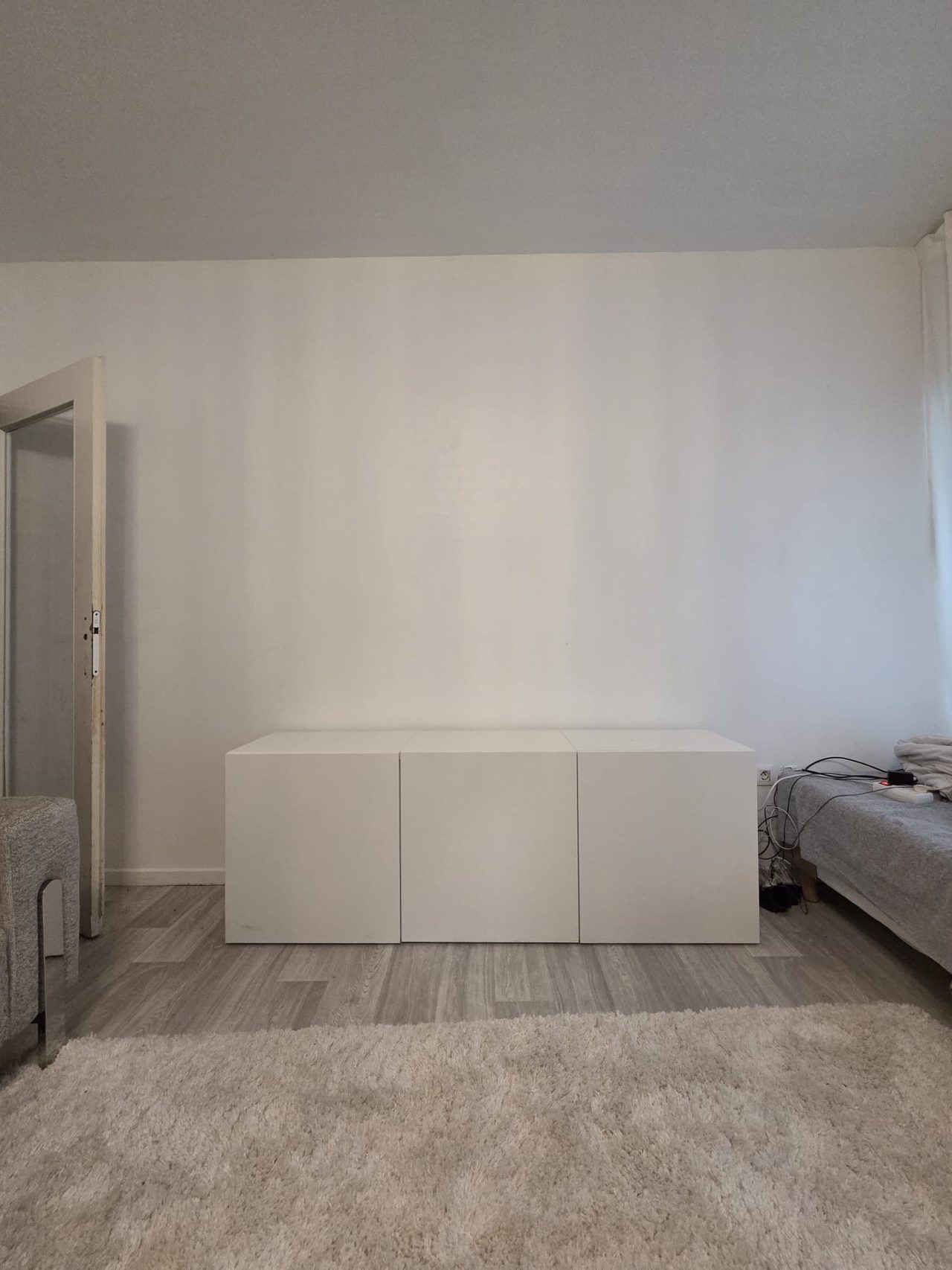 Mur de salon nu avec meuble bas avant l'aménagement